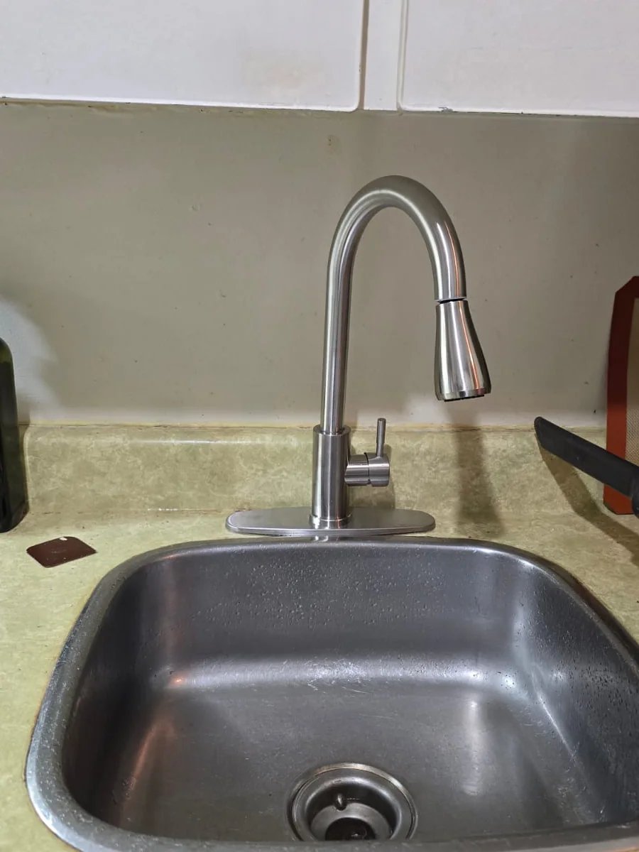 Stainless-steel kitchen sink with a pull-down faucet